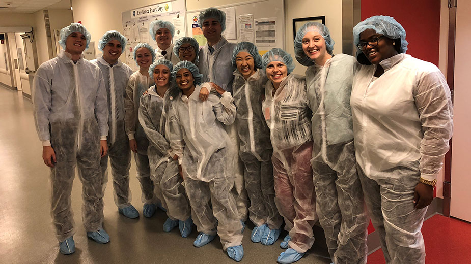 Mass General administrative interns in scrubs during a hospital visit. Mass General administrative interns in scrubs during a hospital visit.
